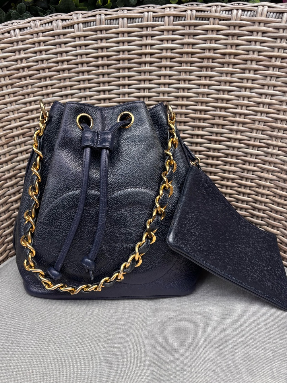 Authentic CHANEL navy caviar leather drawstring bucket with pouch
